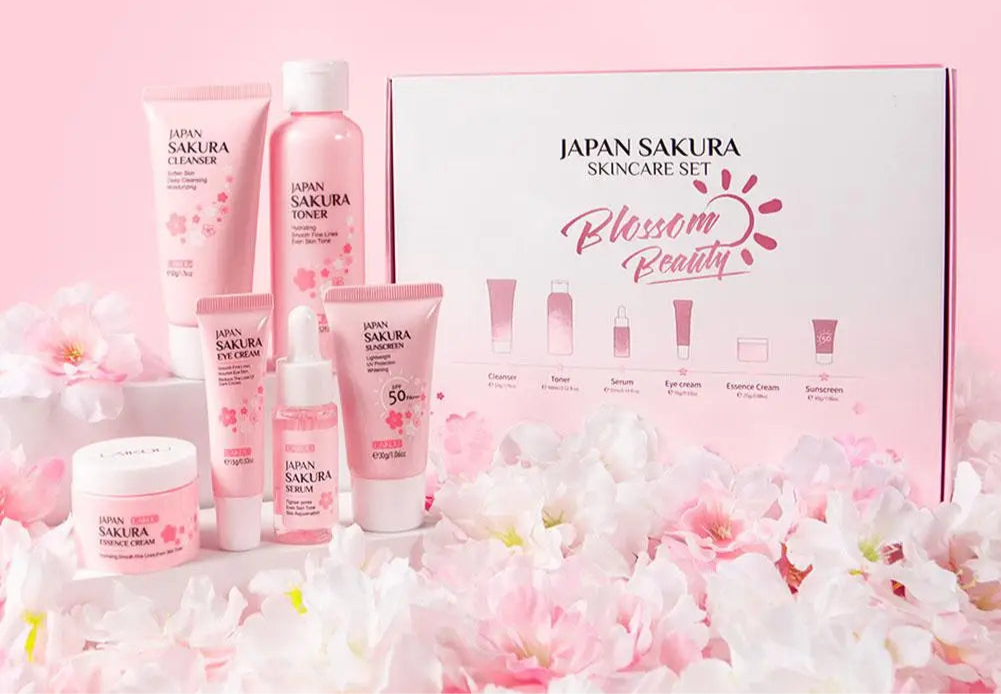 Japan Sakura skincare set with products and packaging on a pink background with cherry blossoms.