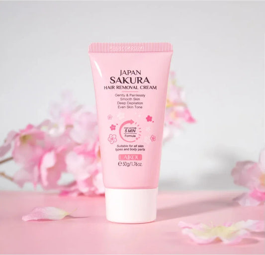 Pink tube of Japan Sakura hair removal cream with cherry blossoms in the background